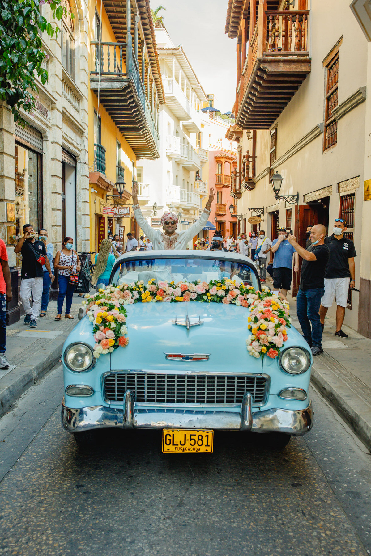 Festive baraat procession featuring the groom's grand arrival, accompanied by lively music and dancing in Cartagena.