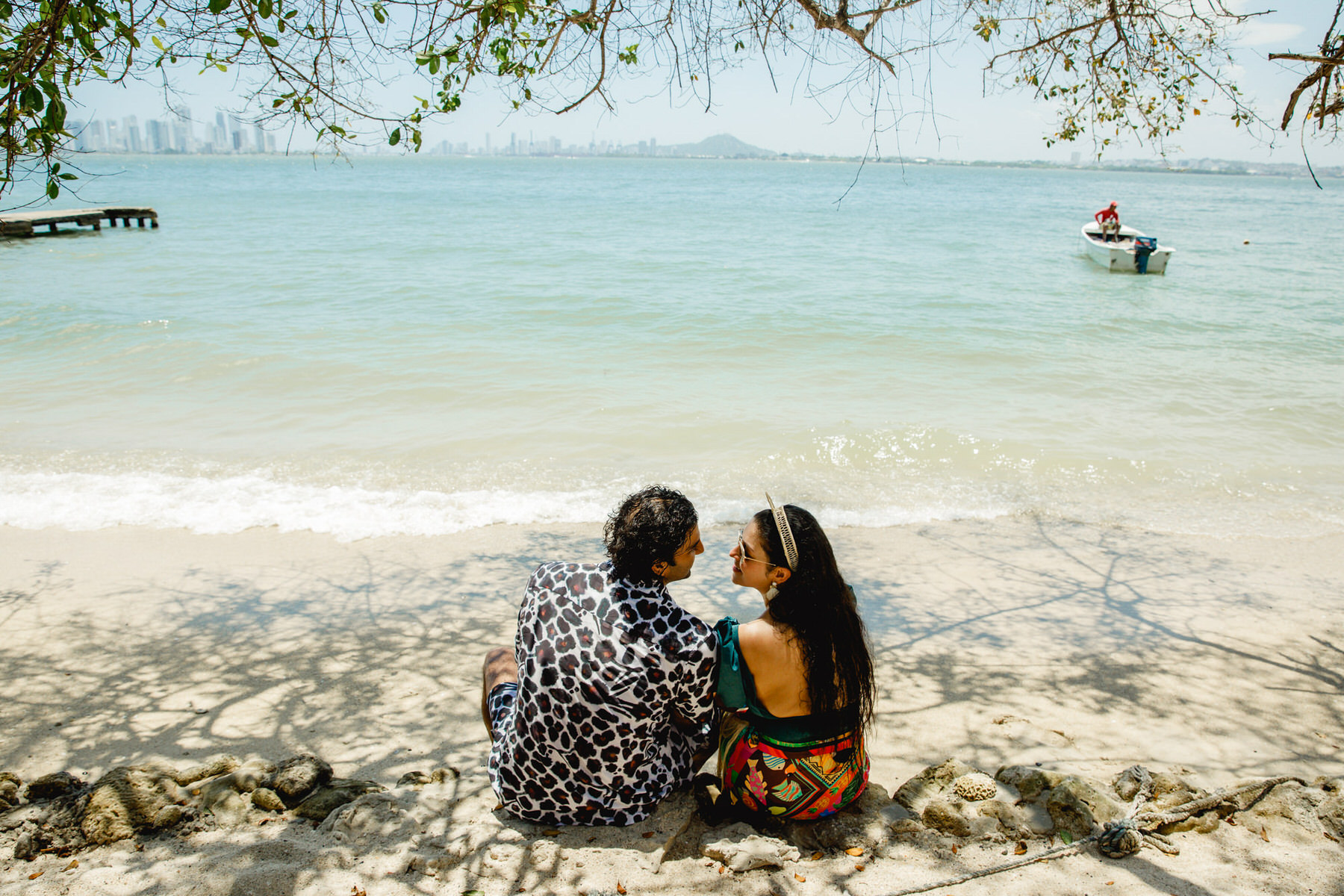 Newlywed couple enjoying a serene moment on the shores of Fenix Tierra Bomba during their day after wedding celebration