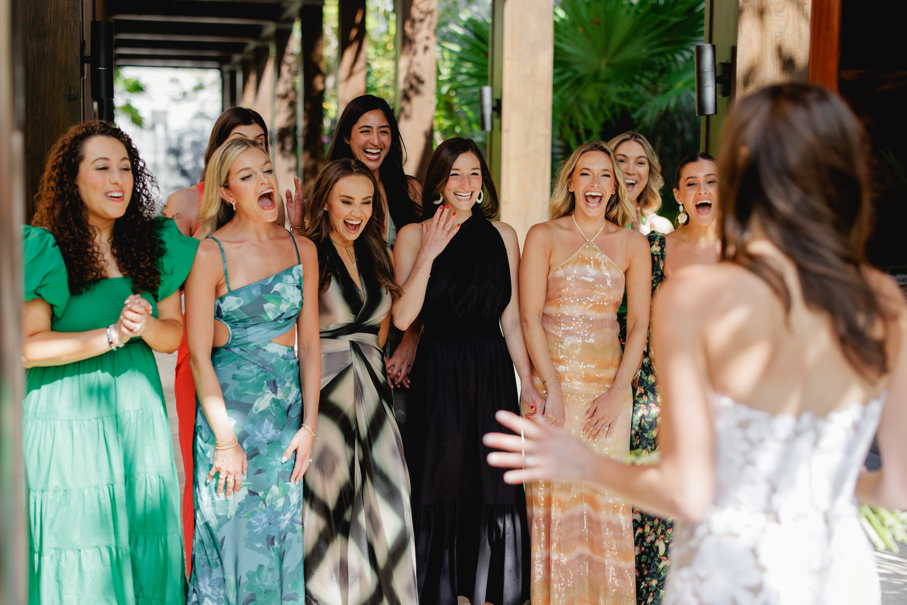 Bride doing a first look ( wedding reveal) with her bridesmaids at a NIzuc wedding 