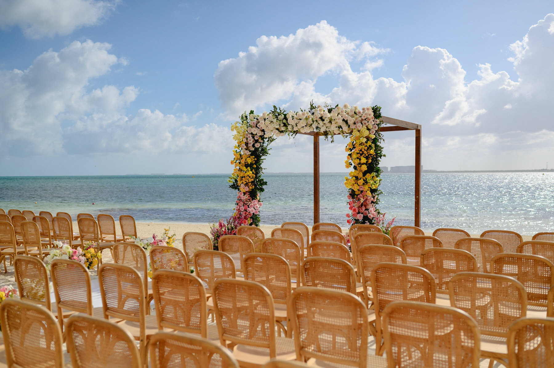 Elegant and colorful wedding decor with a view of the crystal-clear waters at Nizuc Resort and Spa Cancun