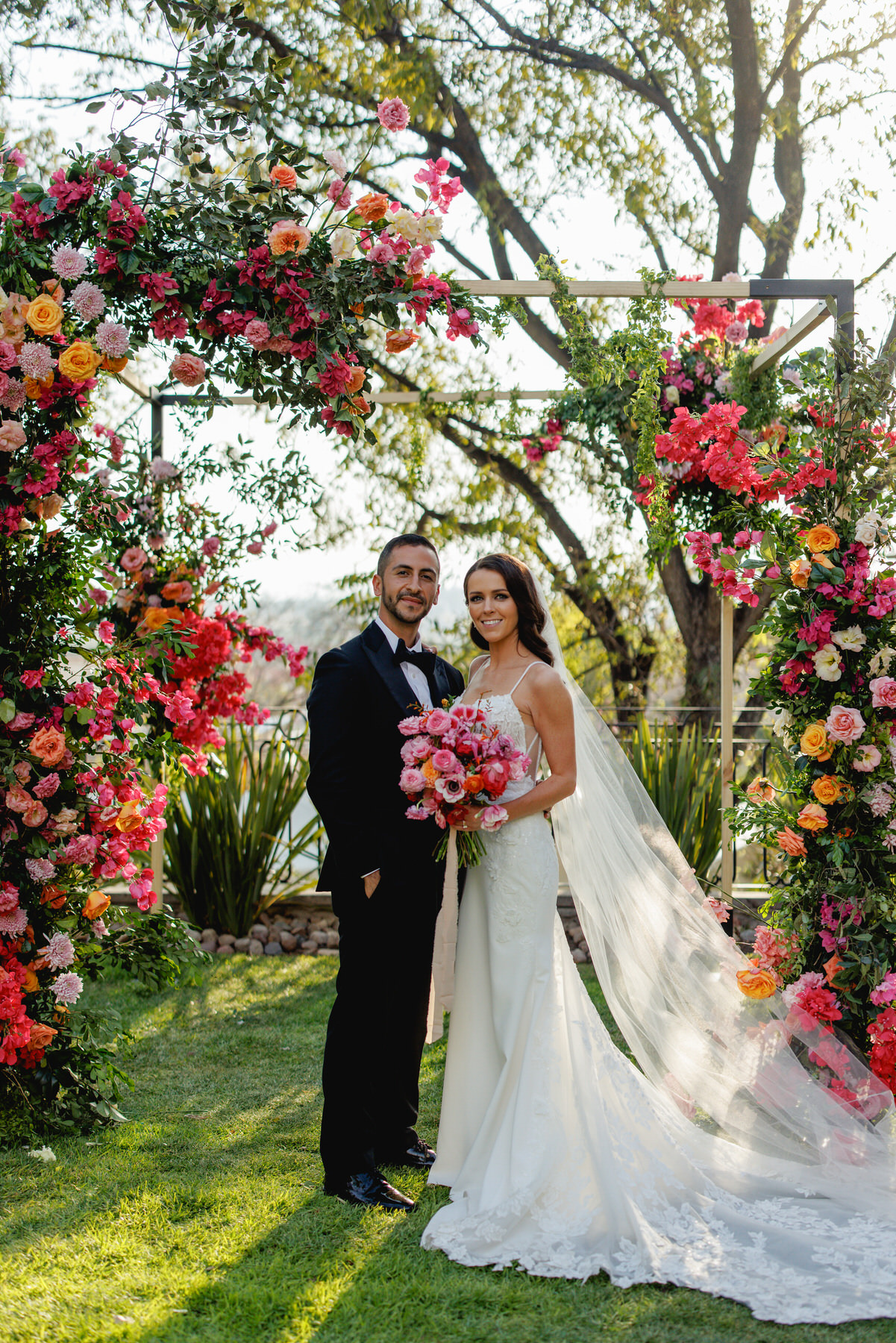 Stunning couple in floral arch in San Miguel de Allende, Mexico