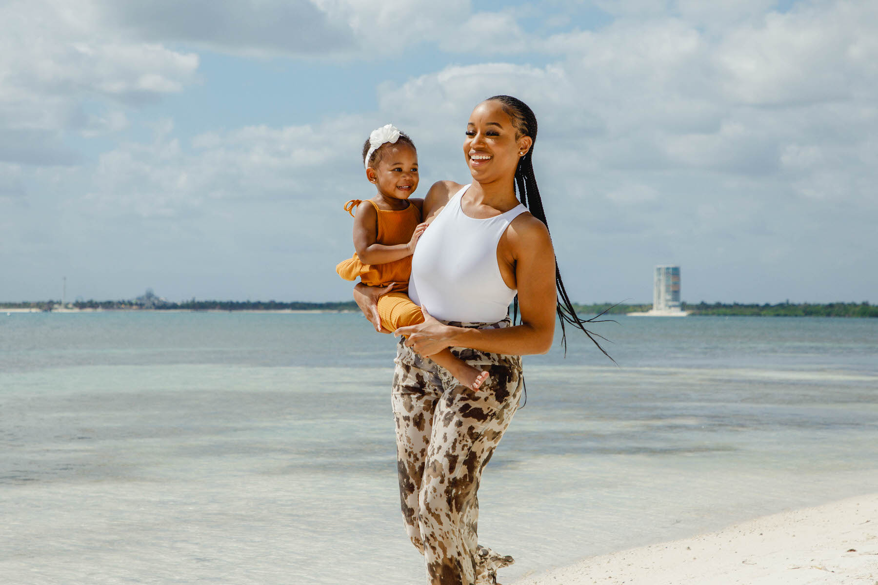 Children having fun and playing on the beach during a family photo session at Nizuc Resort